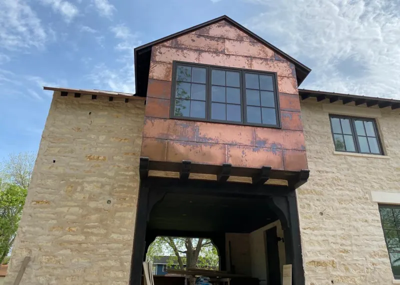 Copper metal panel facade on a stone building for Skylight Installation in Vestal